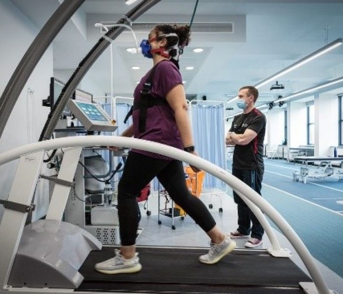 woman using a treadmill while undergoing vo2max testing