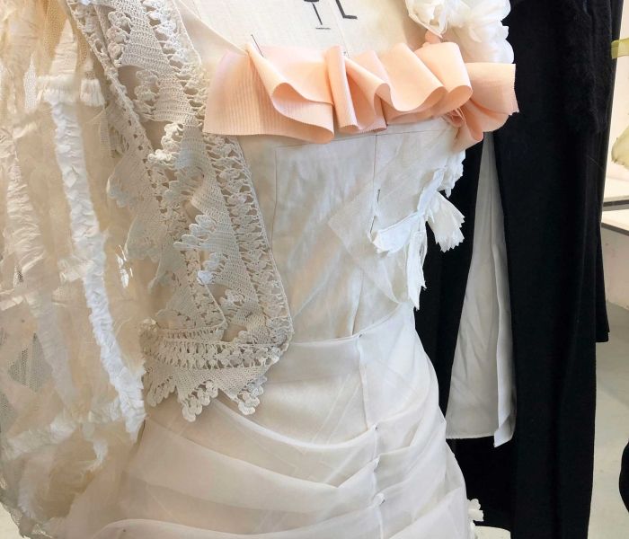 Close up of costume design white dress with ruffles 