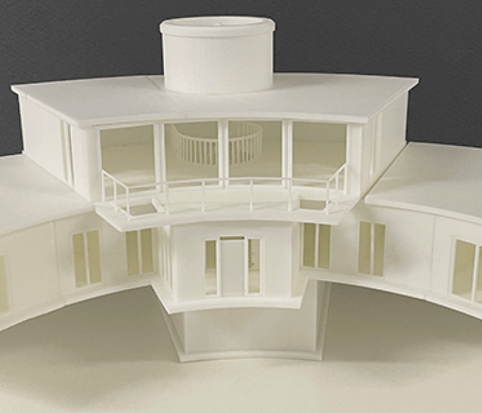 A 3D printed model of a two story building in a semi circle shape