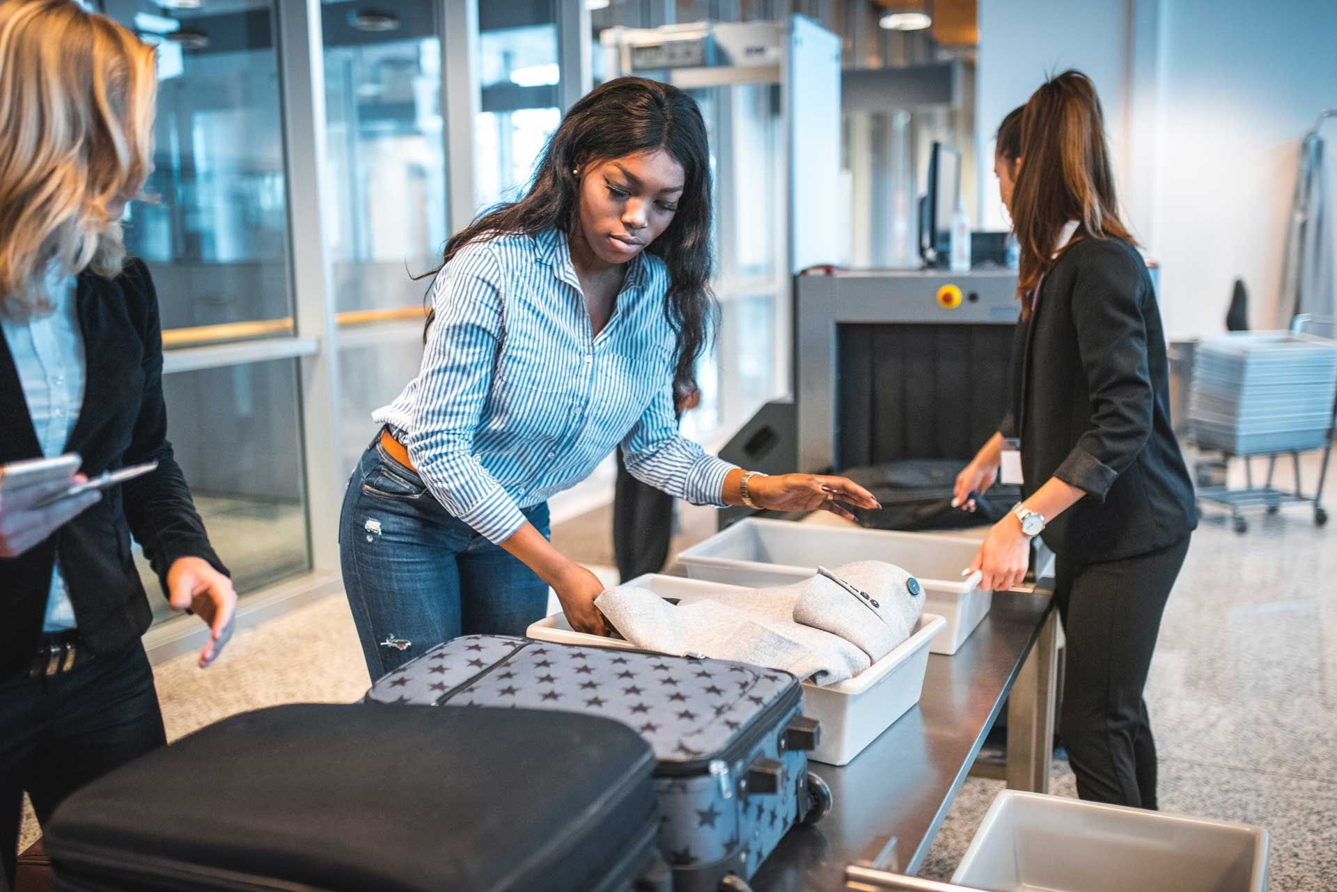 Young Female going through airport security with luggage 