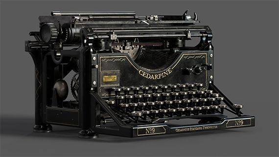 An old fashioned black and gold typewriter against a grey background